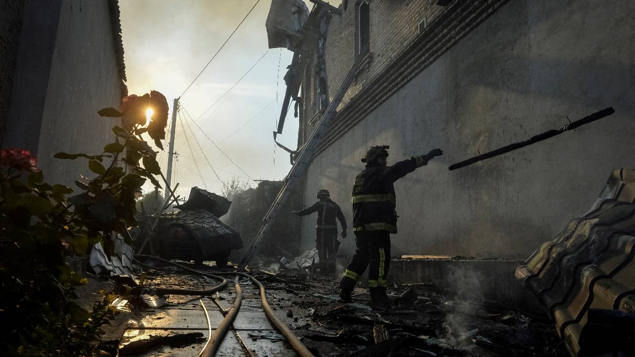 Rescuers work at a site of a house heavily damaged in by shelling during the evacuation of local residents from a flooded area in Kherson. /Oleksandr Klymenko/Reuters