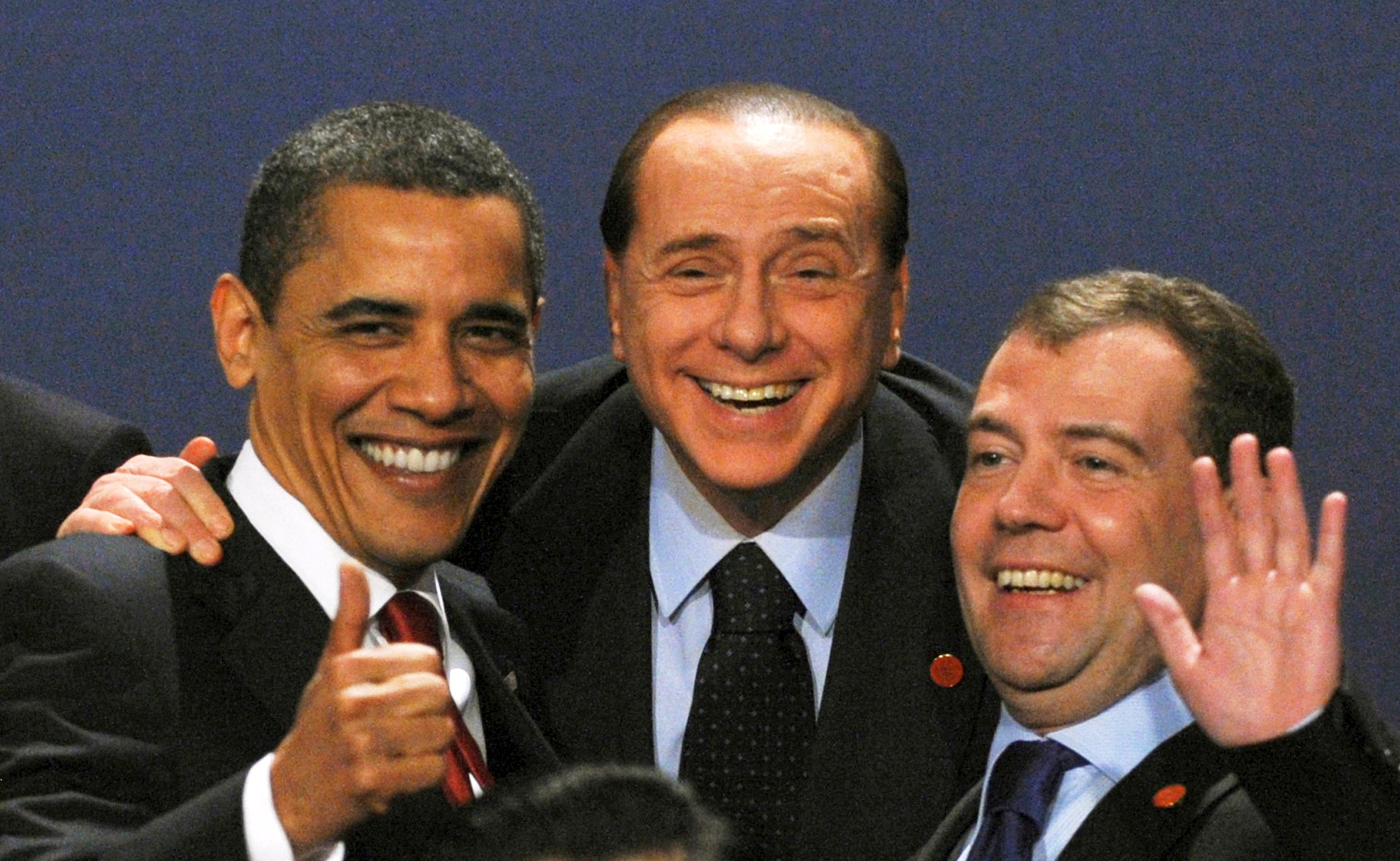 Berlusconi laughs with former U.S President Barack Obama and Russia's then President Dmitry Medvedev at a G20 summit in 2009./Reuters/Stringer.