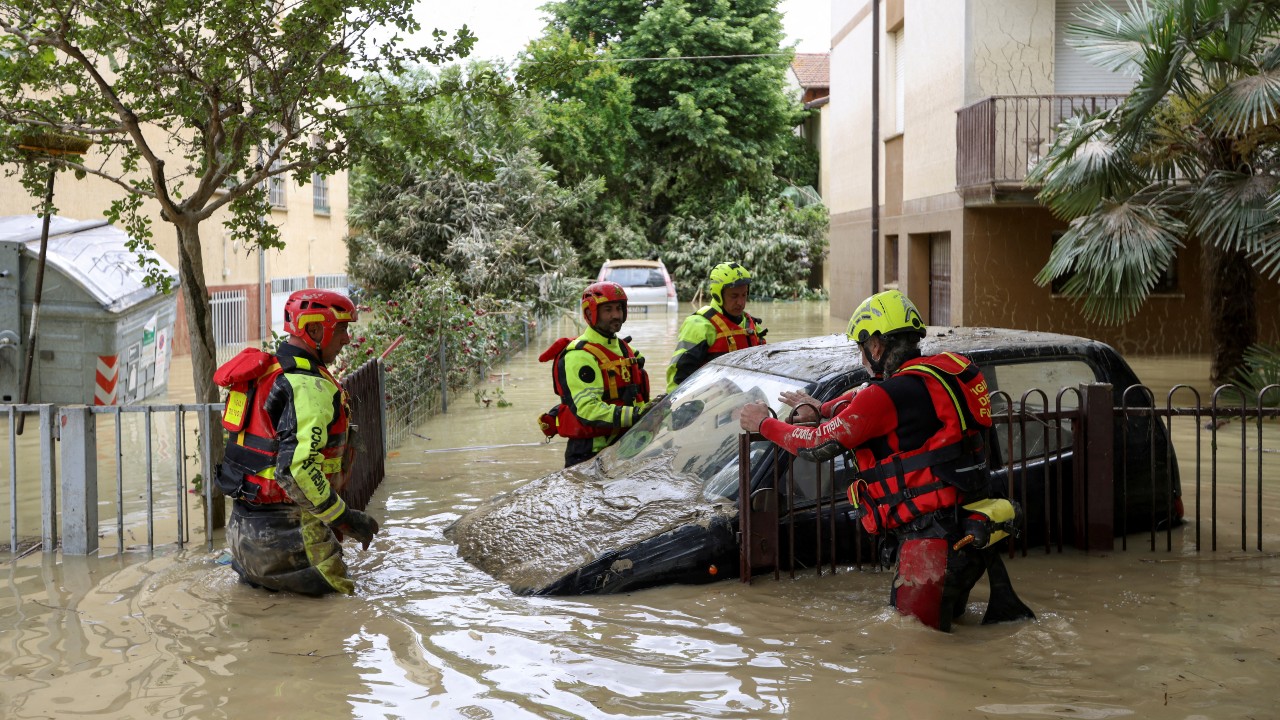Firefighters find a flooded car after heavy rains hit Italy's Emilia-Romagna region in May 2023. /Claudia Greco/Reuters