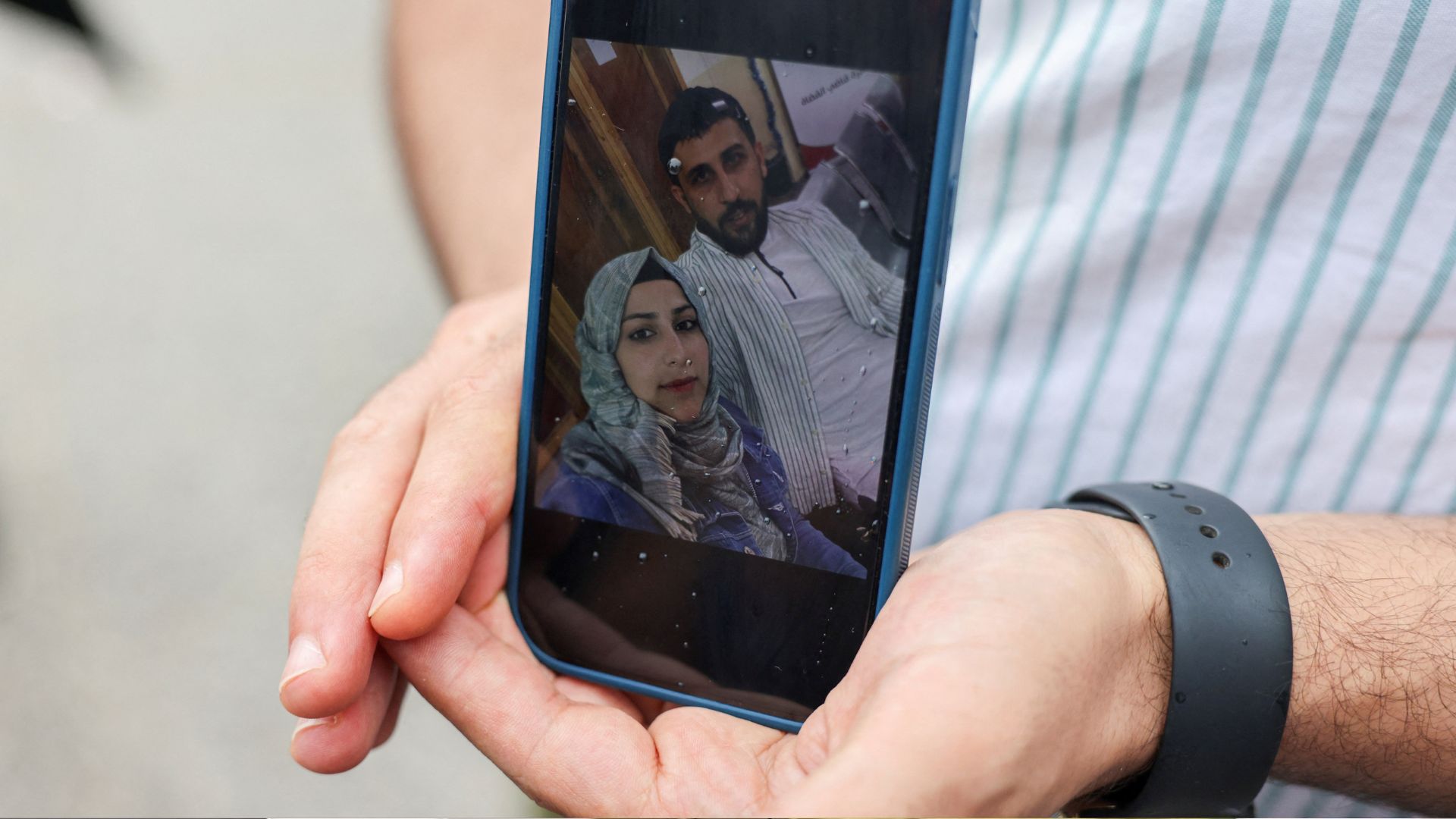 Syrian Kassam Abozeed, shows a photo of him and his wife, believed to have been onboard the vessel. /Stelios Misinas /Reuters