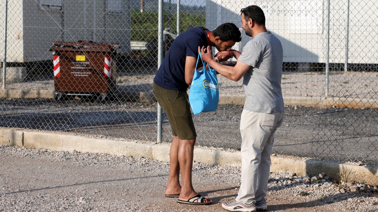 Egyptian survivor Atia Al Said, 22, rescued from the boat off Kalamata, reunites with his uncle Mohamed El Sayed El-Dadamony Radwan at a reception and identification camp in Malakasa, Greece. /Stelios Misinas/Reuters