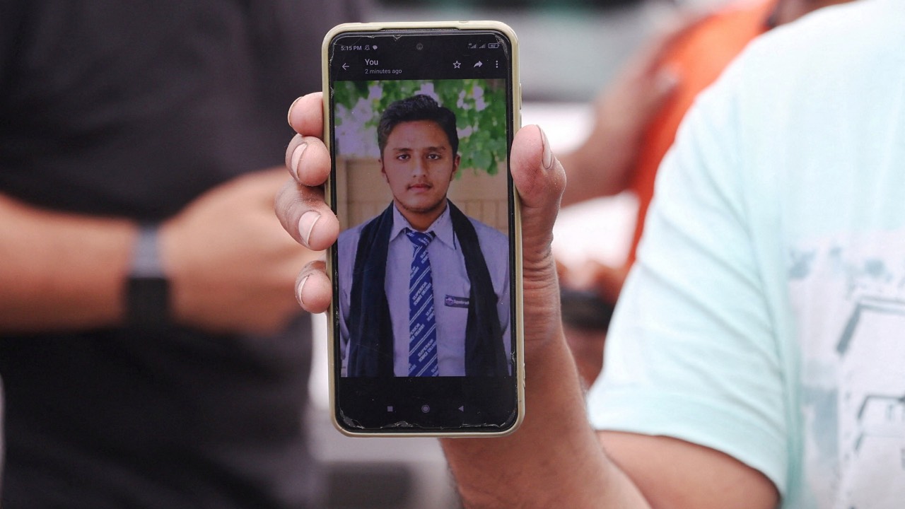 Pakistani Hassan Ali shows a picture of his 21-year-old brother Fahad, whom he says was onboard the boat that capsized off Kalamata. /Louiza Vradi/Reuters