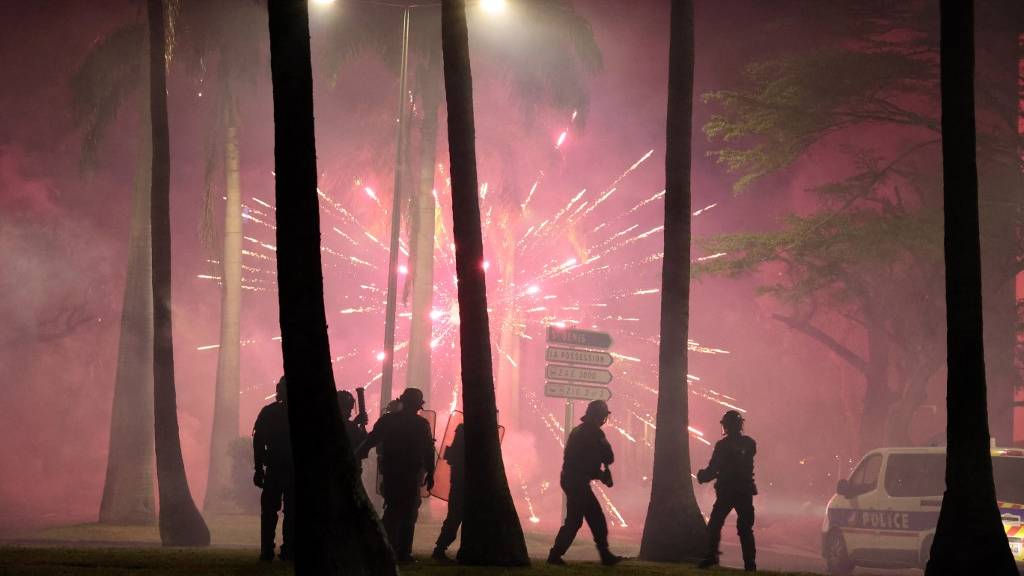 Fireworks explode during clashes with police in Le Port, French Indian Ocean island of La Reunion. /Richard Bouhet/AFP