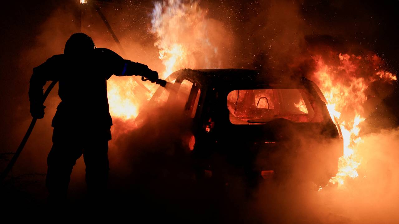 Firefighters deal with burning cars during the fifth day of protests in Tourcoing, France. /Pascal Rossignol/Reuters