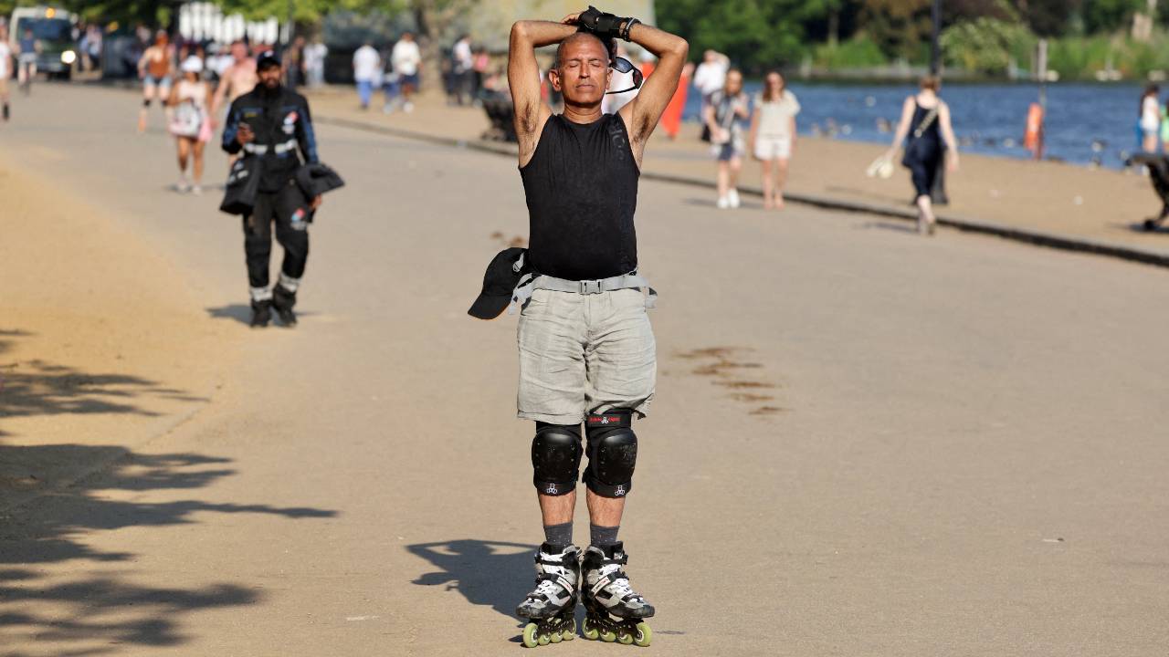 A roller skater takes a break in the sun in London's Hyde Park as the UK reported record temperatures for June. /Kevin Coombs/Reuters