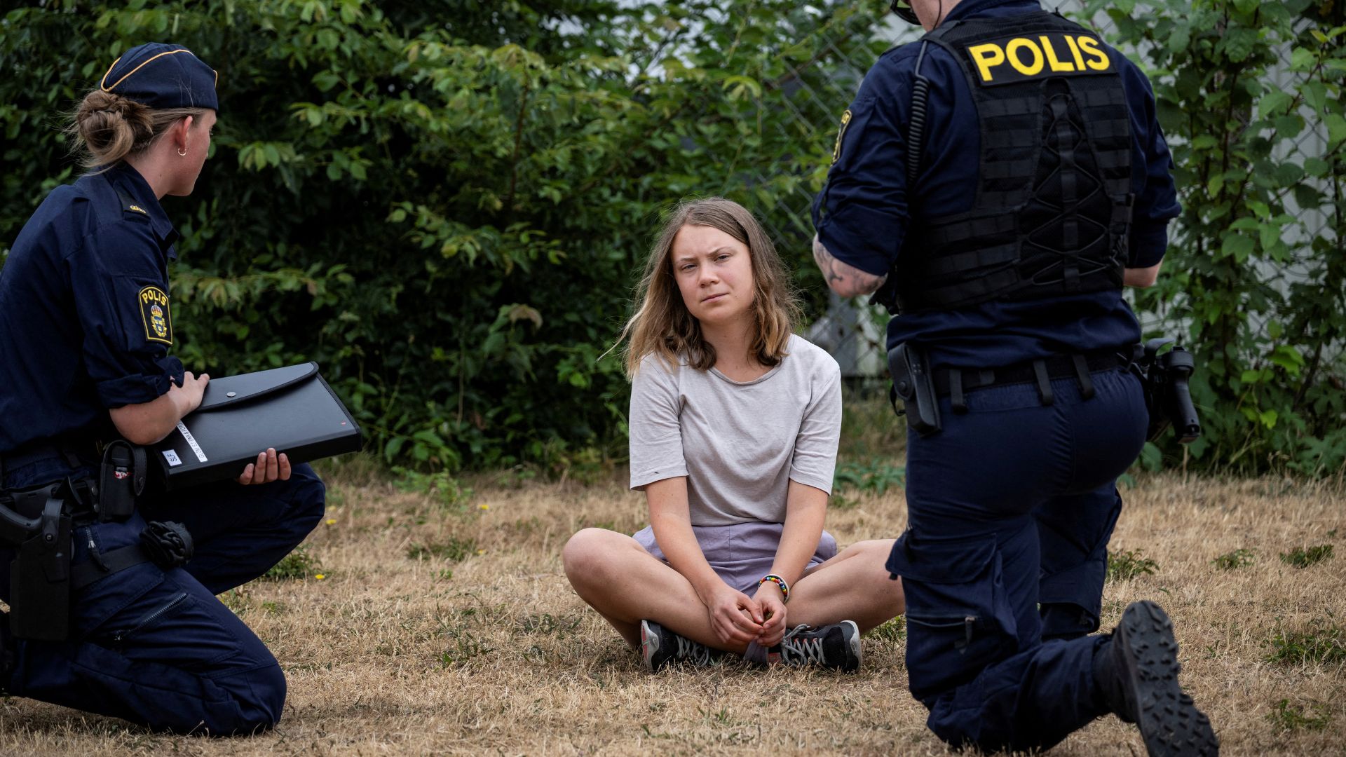 Police talk to Greta Thunberg as her and other climate activists in Malmo refused to leave a protest on June 19. /TT News Agency/Johan Nilsson via Reuters