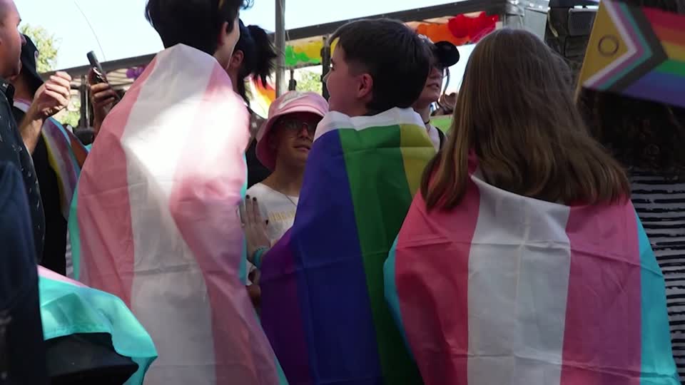 Youths at a Spanish Pride LGBT march wrap themselves in trans flags. /Reuters
