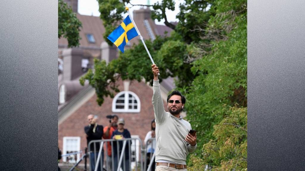 Protestor Salwan Momika, who planned to burn a copy of Koran and the Iraqi flag, waves a Swedish flag outside the Iraqi embassy in Stockholm. /TT News Agency/Caisa Rasmussen/Reuters