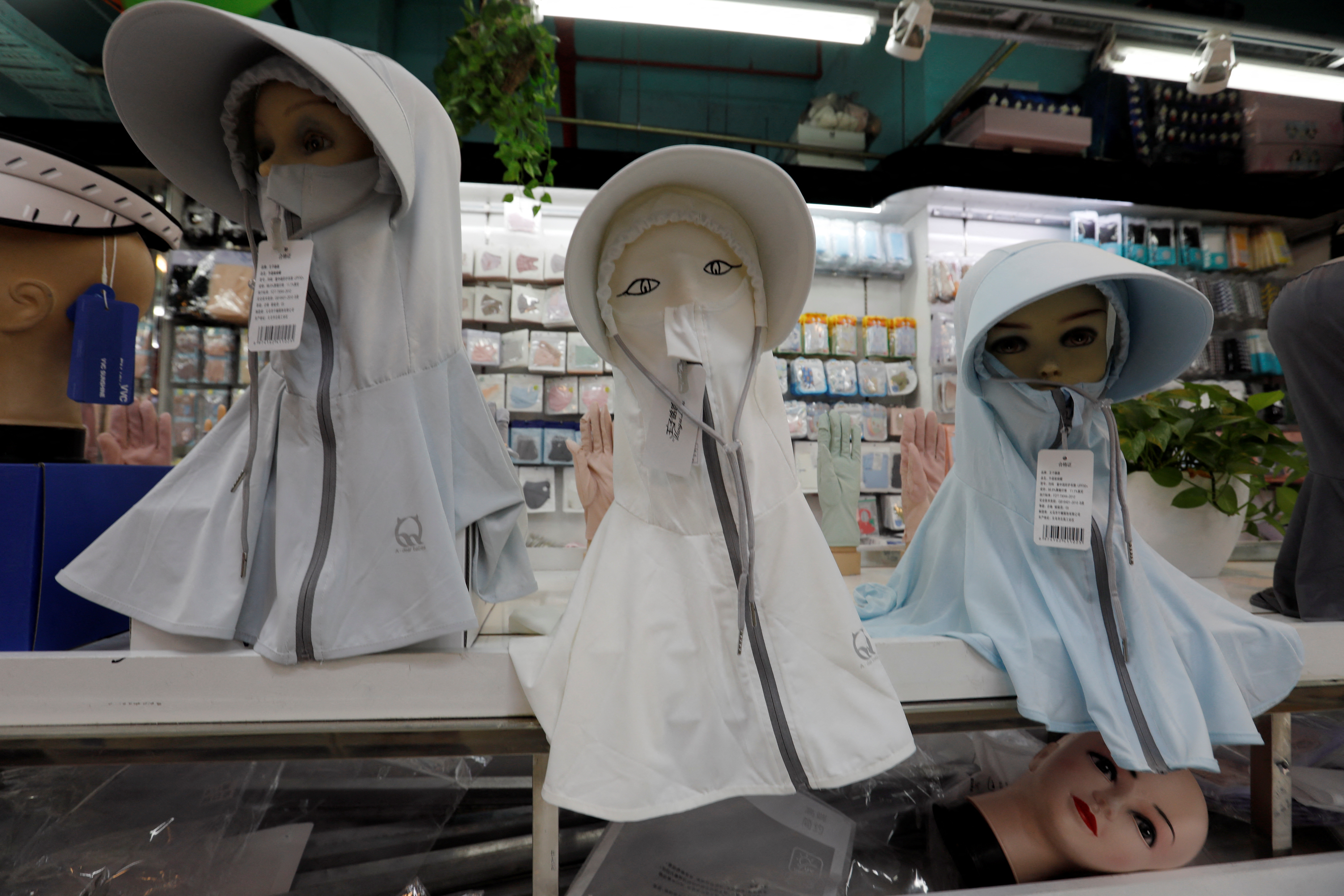 Sun protection headgear – seen here during a heatwave in Beijing – could become an essential item as European temperatures continue to soar during the summer months. /Florence Lo/Reuters