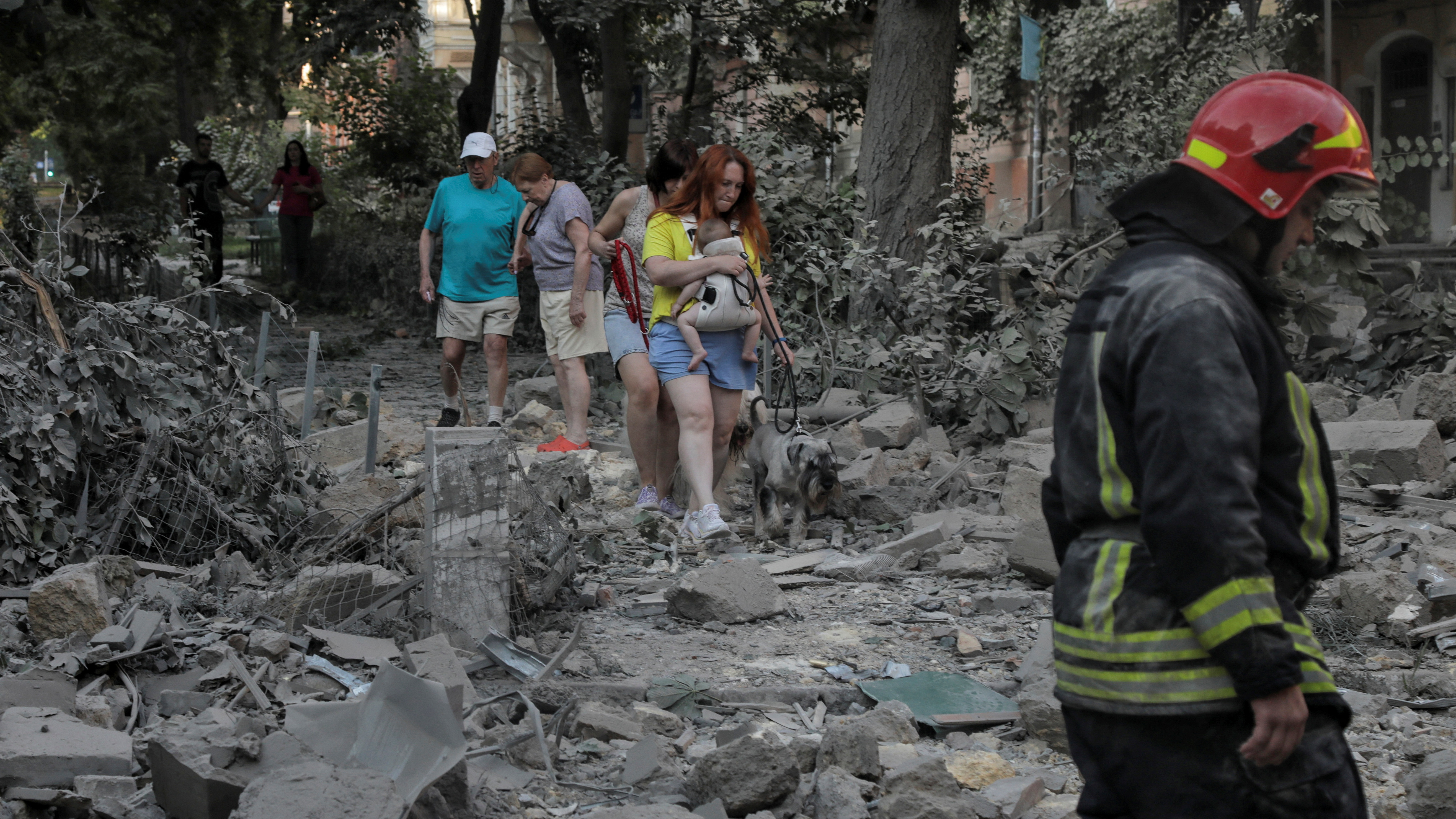 Local residents walks across debris at a site of a residential building damaged during Russian missile strikes, amid Russia's attack on Ukraine, in Odesa, Ukraine July 23, 2023. REUTERS/Nina Liashonok