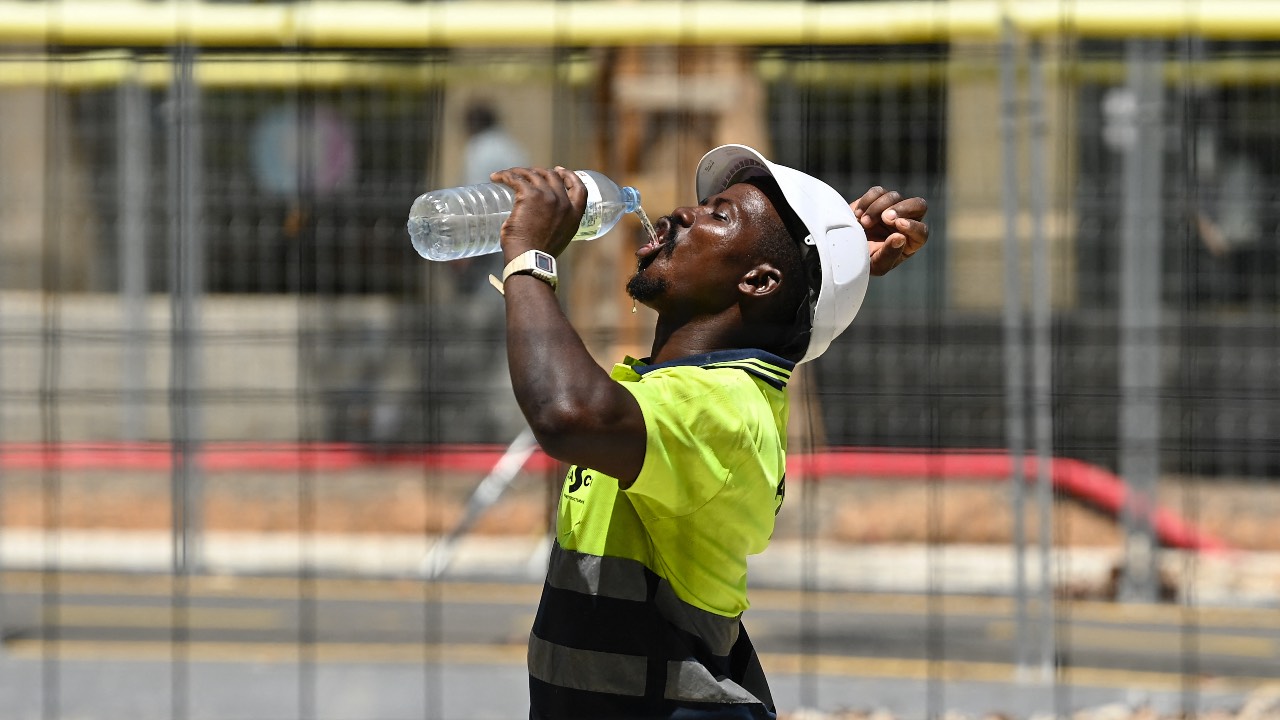 A construction worker drinks water in Barcelona. Spain issued hot weather red alerts for three regions due to the 