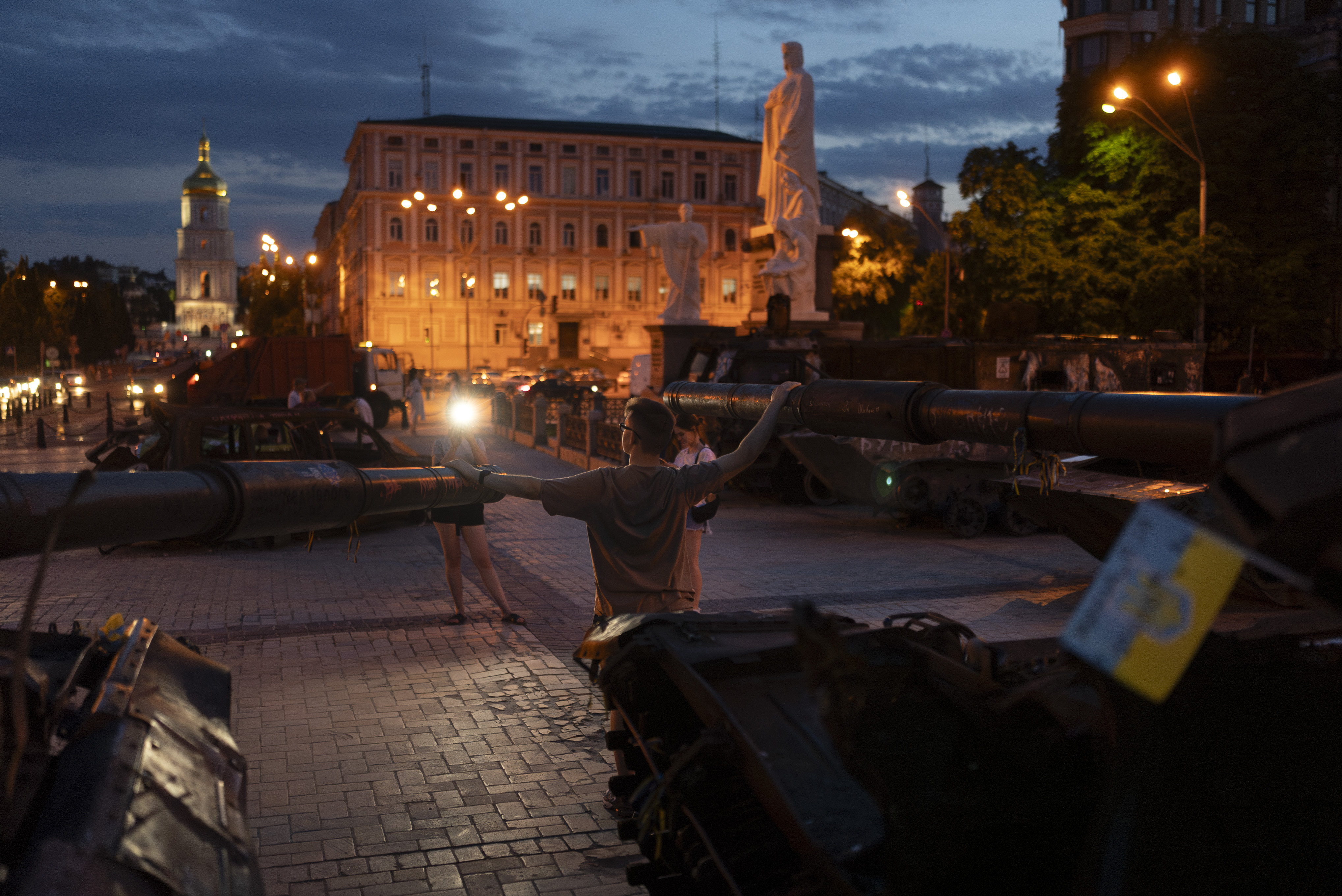 A man poses for photos with destroyed Russian tanks exhibited in the Saint Michael's Square in Kyiv last week. /Jae C. Hong/AP