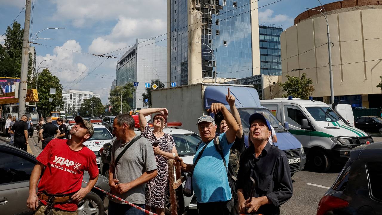 Local residents look on near a building damaged during a Russian drone strike  in Kyiv. /Gleb Garanich/Reuters