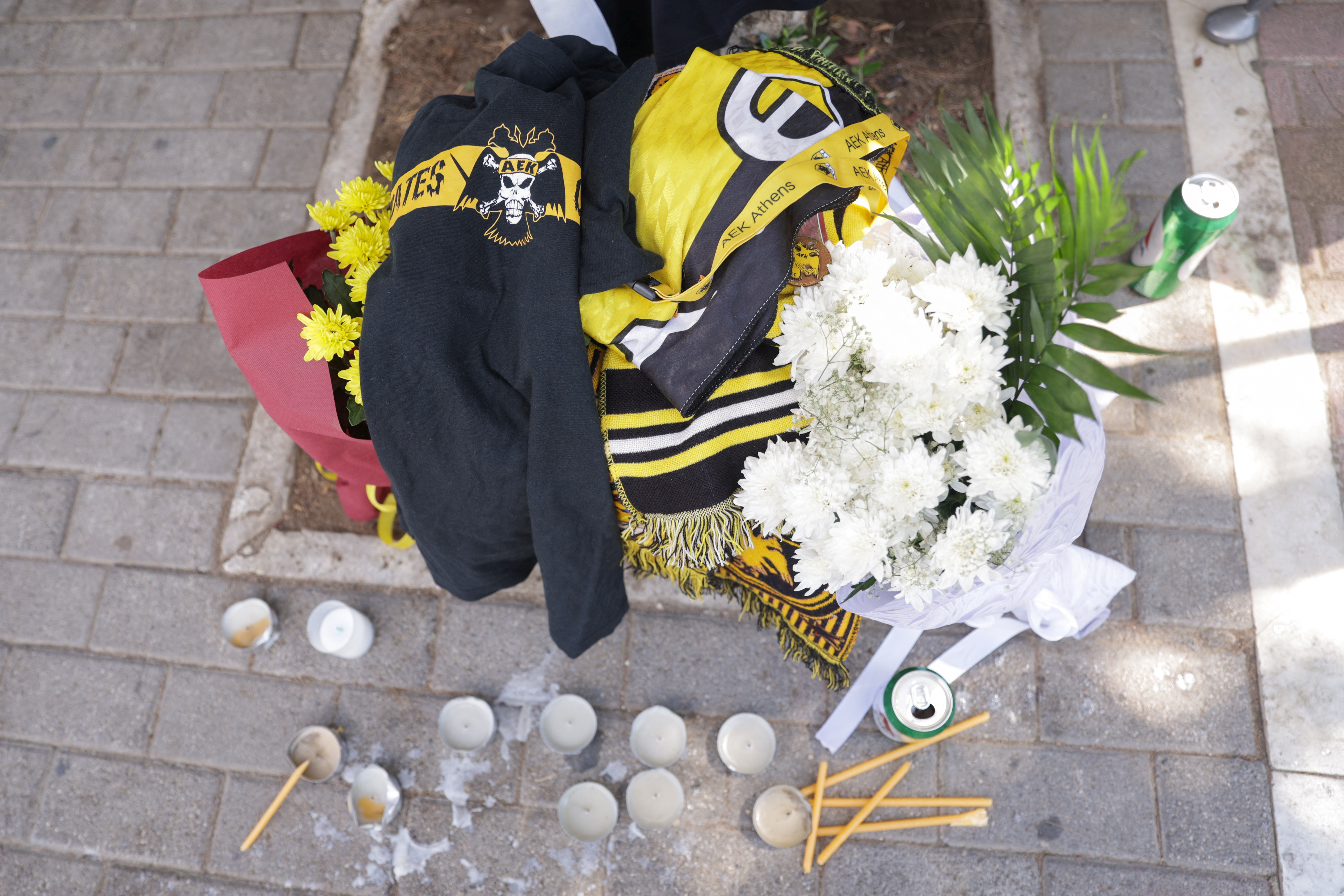 Candles, flowers and club shirts are seen outside the stadium. /Reuters/Louiza Vradi.