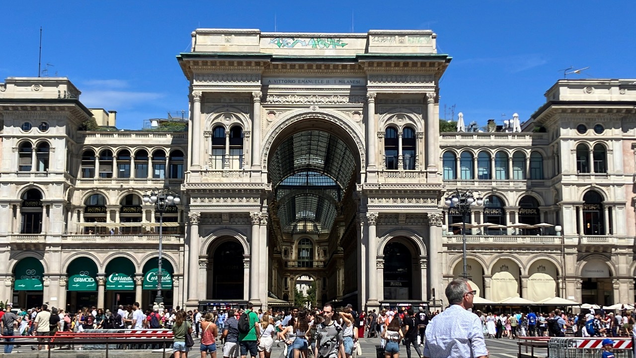 People walk past Galleria Vittorio Emanuele II after it was tagged by graffiti artists in Milan, Italy. /Viviana Venturi/Reuters