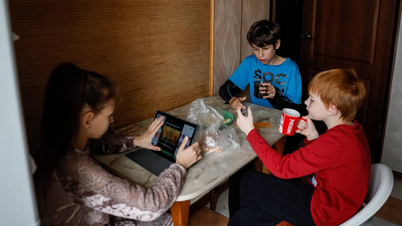 Ivan, 12, and Oleksandra, 10, children of Liubov Borniakova, are pictured in their apartment in Dnipro. Her cousin Serhii adopted Borniakova's children after her death. /Alina Smutko/Reuters