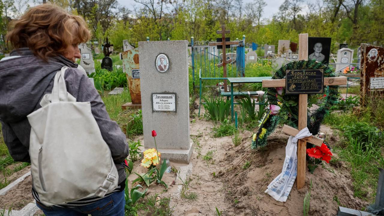 Kateryna Vedrentseva, an aunt of Liubov Borniakova, stands near Liubov Borniakova's grave at a local cemetery in Dnipro. /Alina Smutko/Reuters