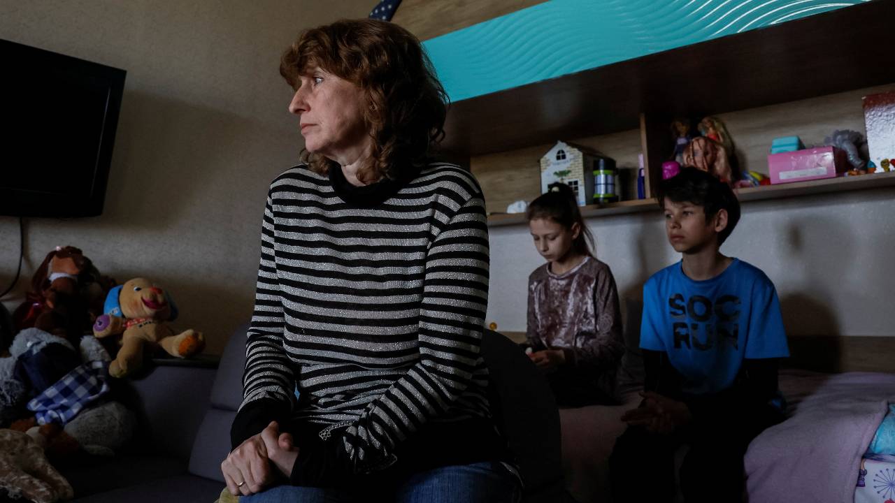 Kateryna Vedrentseva, aunt of Liubov Borniakova, and her great-nephews – Ivan, 12, and Oleksandra,10 – are pictured in their apartment in Dnipro. /Alina Smutko/Reuters