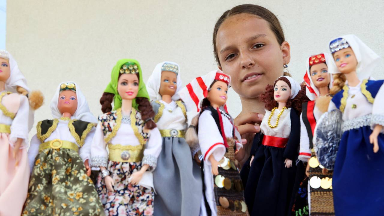 Esma Gljiva, an 11-year-old Bosnian girl, shows off the dolls that she dresses in her homemade traditional Bosnian costumes. /Amel Emric