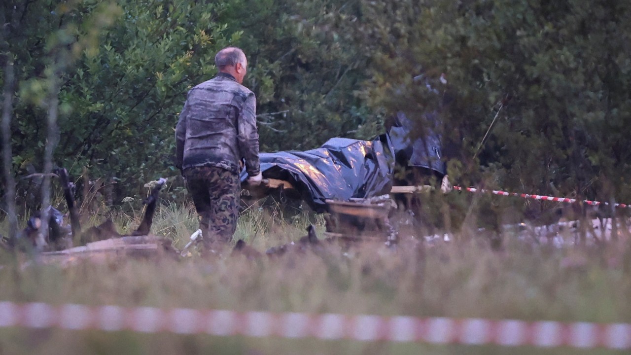 Emergency specialists carry a body bag near the wreckage of the private jet linked to Wagner mercenary chief Yevgeny Prigozhin. /Marina Lystseva/Reuters