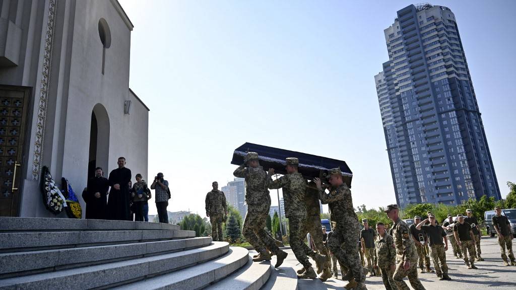 Ukrainian servicemen carrying the coffin of a pilot who helped lead Kyiv's push for U.S. F-16s after his death last week during a training flight. /Sergei Chuzavkov/AFP