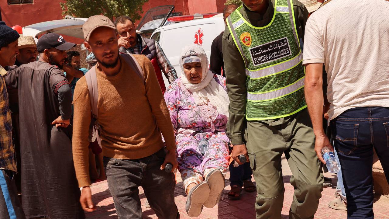 A woman who was rescue is carried away on a stretcher in Amizmiz. /Nacho Doce/Reuters