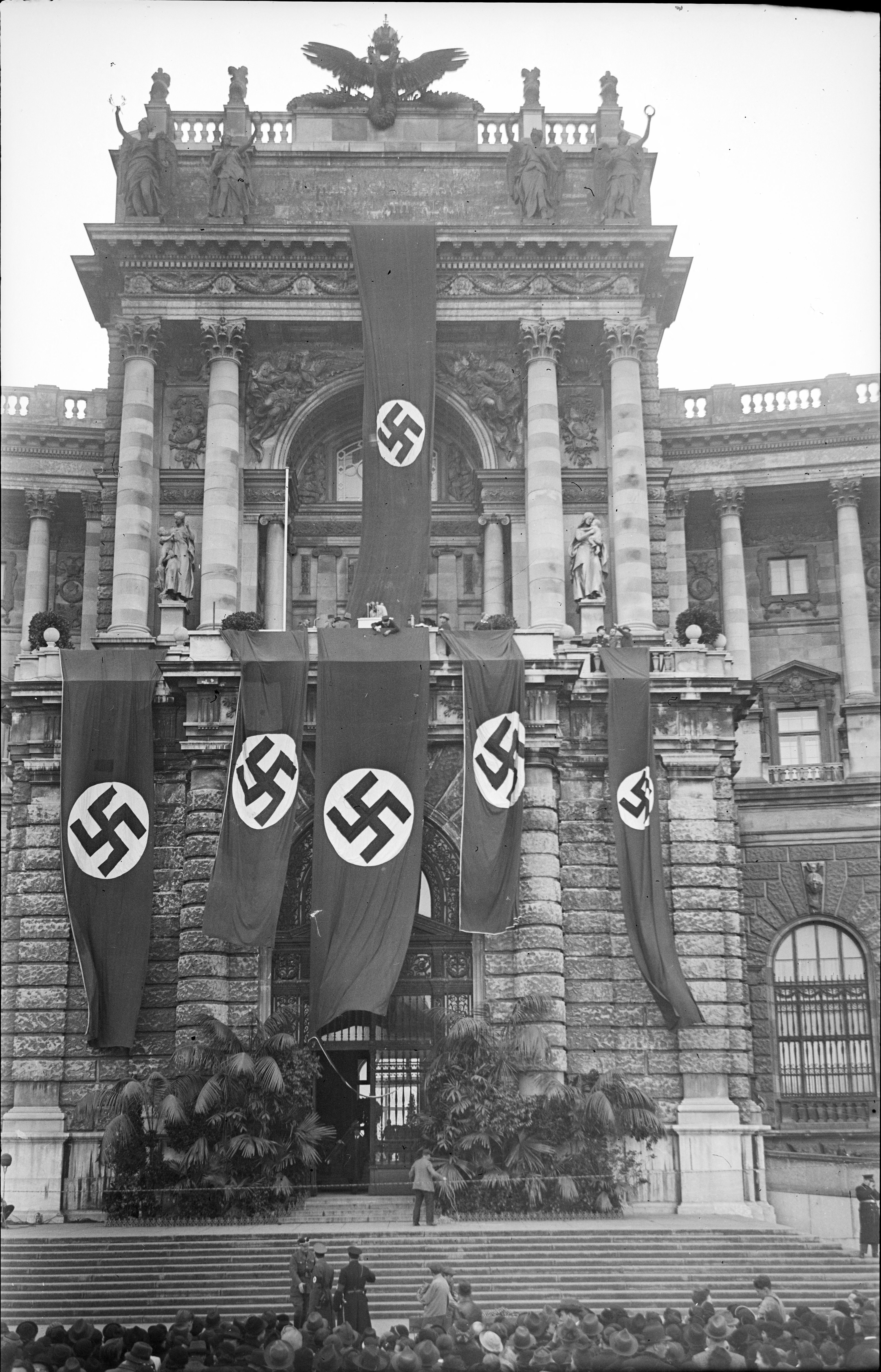 This photo taken on March 15, 1938 shows people gathering prior to a speech by Adolf Hitler, which he delivered from the balcony, after the Nazis annexed his homeland Austria. /Herbert Glockler/APA/Austrian National Library/AFP