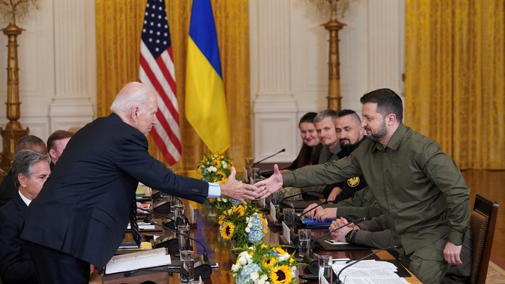 U.S. President Joe Biden and Ukraine President Volodymyr Zelenskyy shake hands across the table during a meeting in the East Room of the White House in Washington. /Kevin Lamarque/Reuters