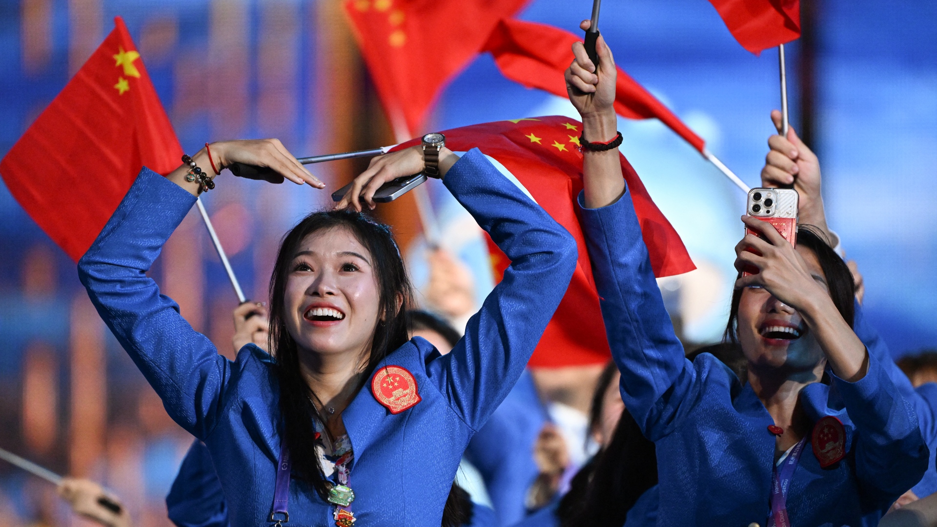 A member of China's delegation enjoying the opening ceremony of the 2022 Asian Games./William West/AFP