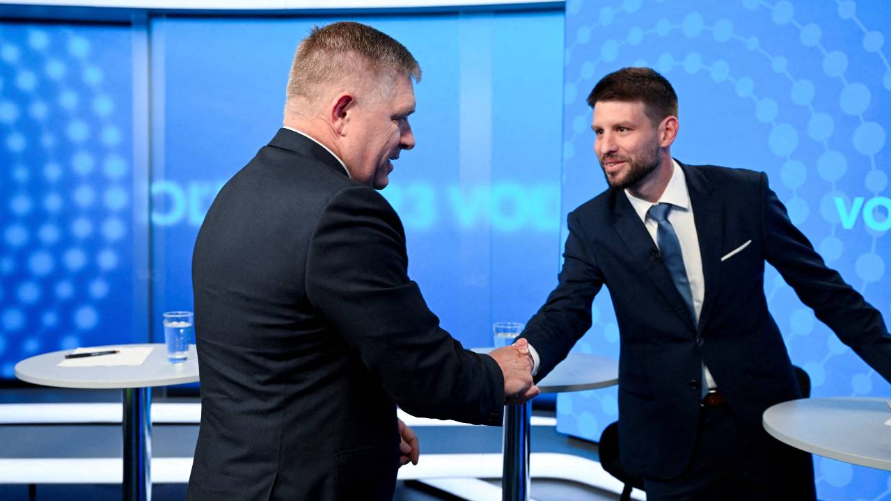 Robert Fico, leader of the Smer-SD party, and Michal Simecka, leader of the Progressive Slovakia party, greet each other with a handshake before a televised debate. /Radovan Stoklasa/Reuters