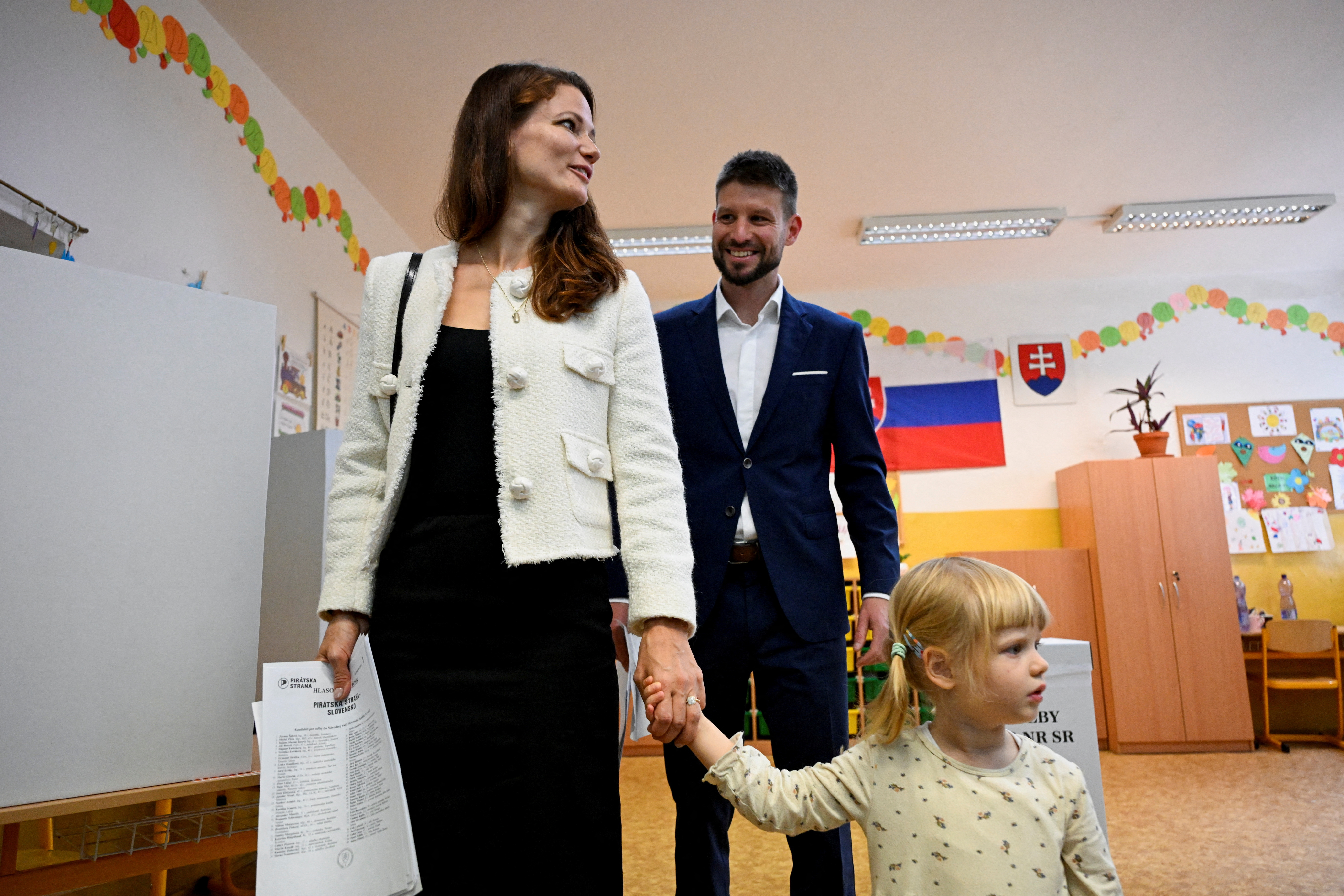Michal Simecka, leader of the Progressive Slovakia party, with his partner and daughter at a polling station during the country's early parliamentary election in Bratislava. /Radovan Stoklasa/Reuters