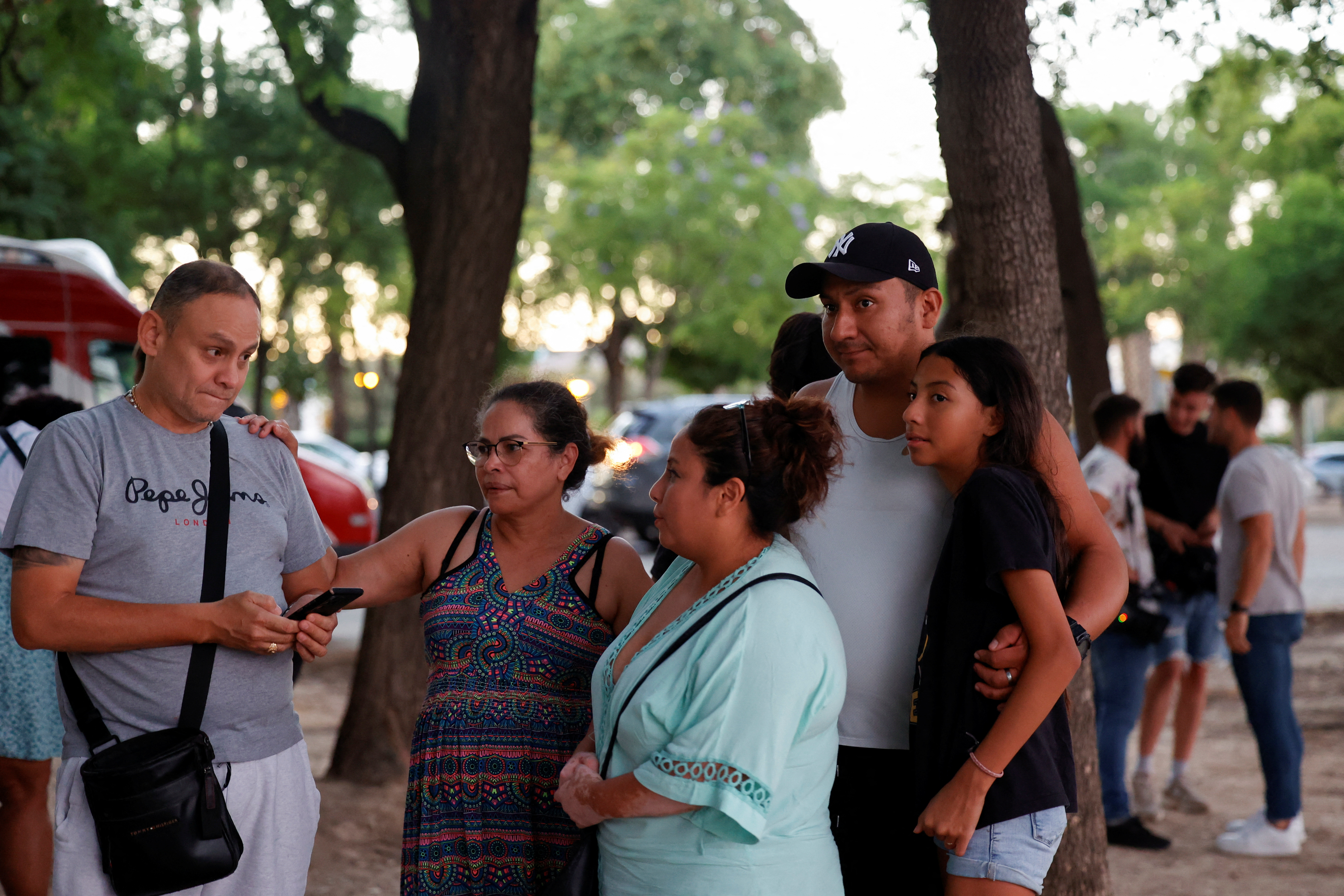 People stand outside a sports hall, where relatives of victims of the
fire have received support. /Eva Manez/ Reuters