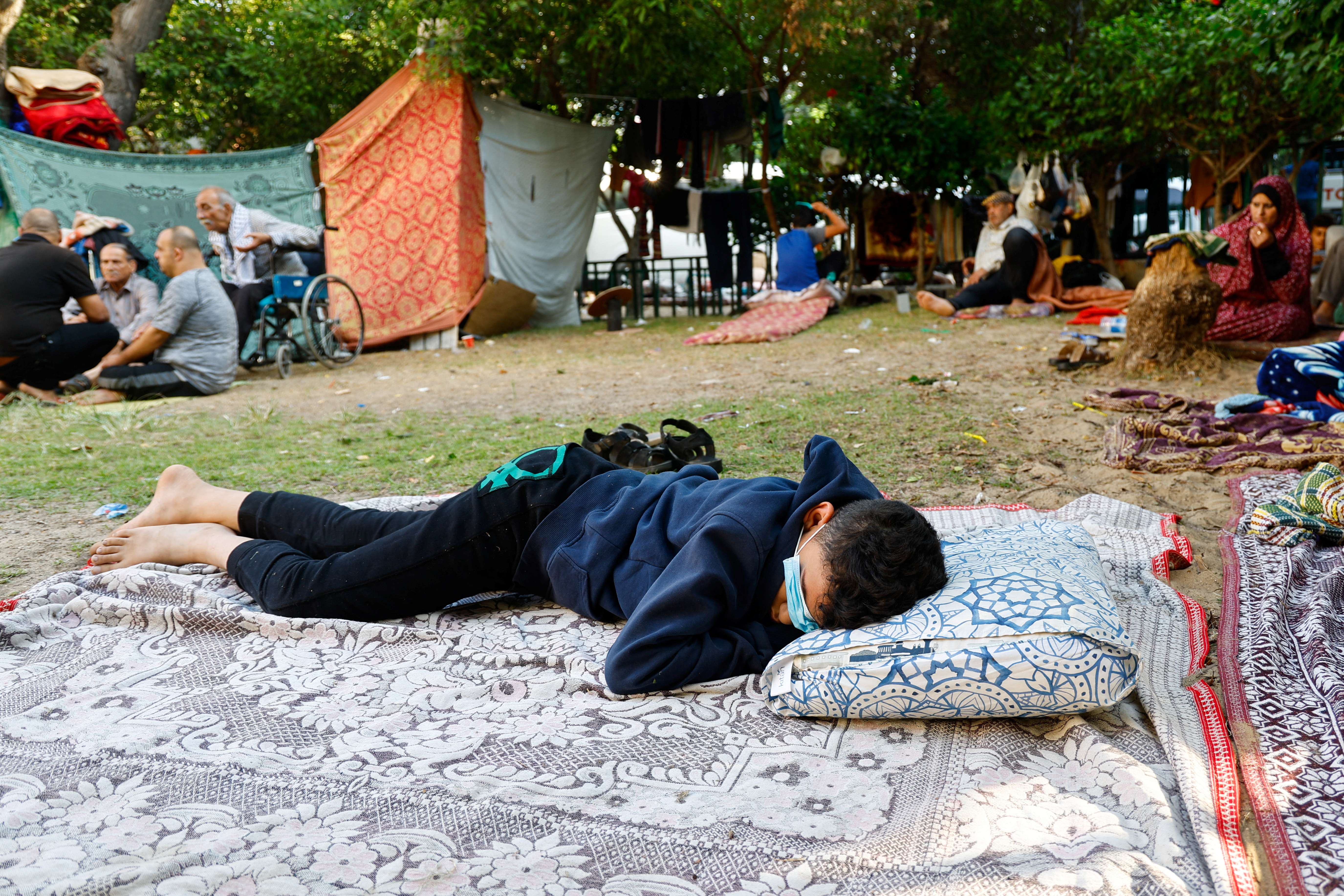 A boy rests at al-Shifa hospital in Gaza City after fleeing his home amid Israeli air strikes. /Mohammed Salem/Reuters
