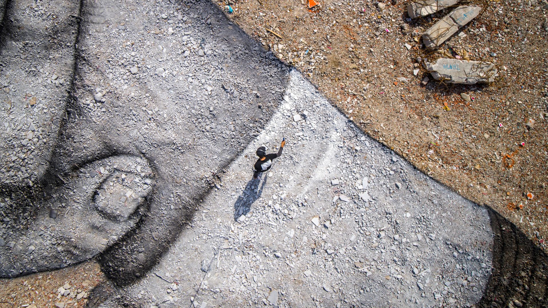 Saype working on his giant biodegradable landart painting. /Handout / LeSabe / AFP