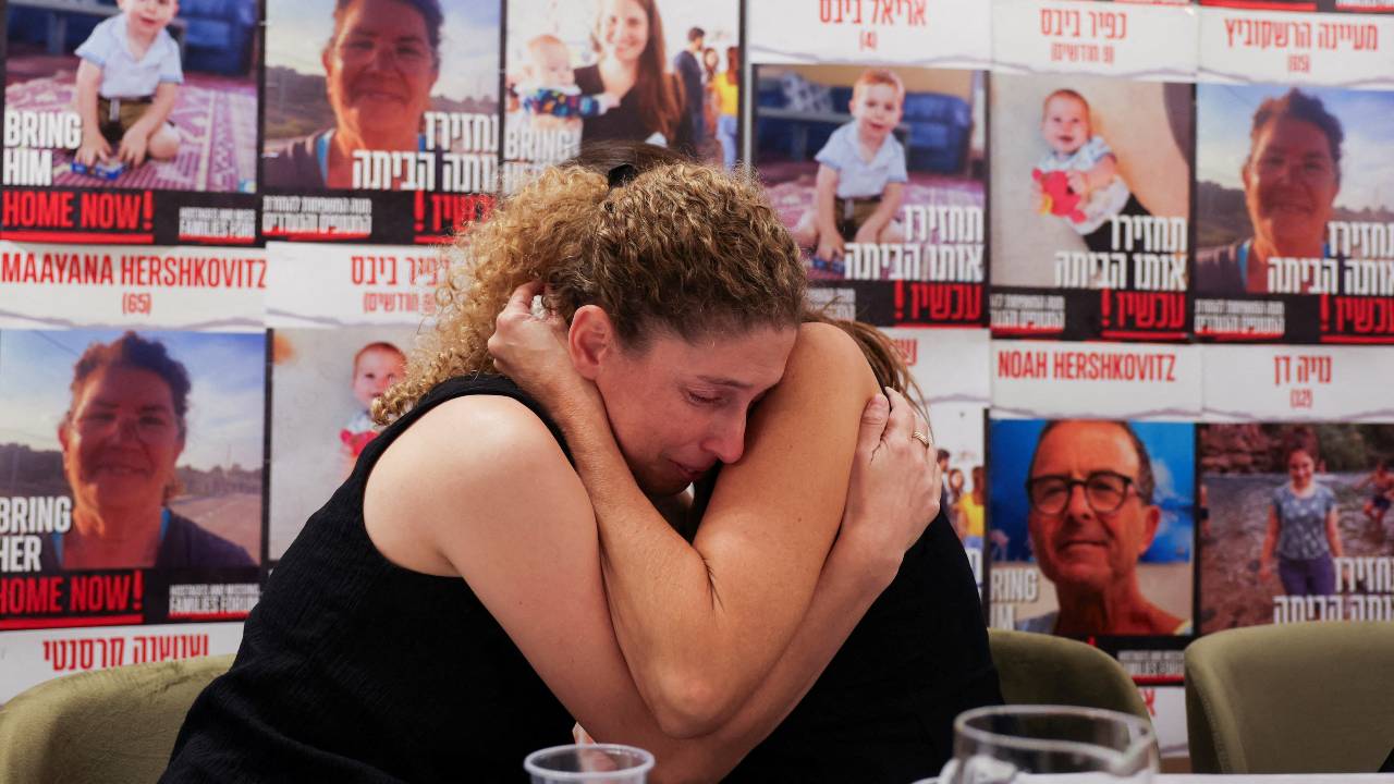 Dr. Adva Gutman-Tirosh and Lee Dan, whose family members were abducted and taken into Gaza, comfort each other. /Ronen Zvulun/Reuters