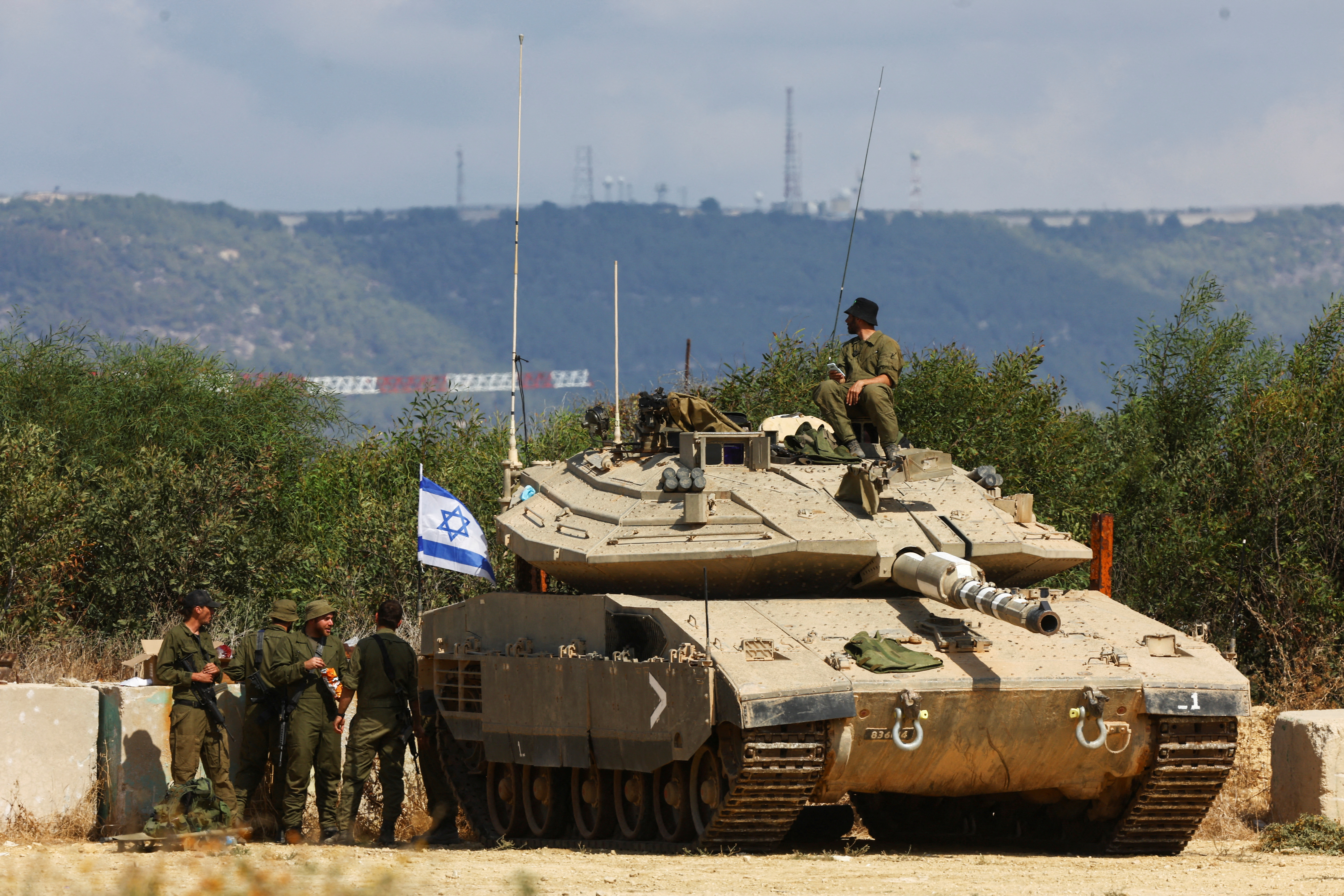 Israel is expected to mount a ground offensive in Gaza in the coming days. In this picture, Israeli troops stand guard near its border with Lebanon. /Reuters/Lisi Niesner.