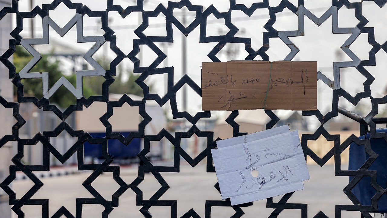 Cardboard signs with text in Arabic reading 