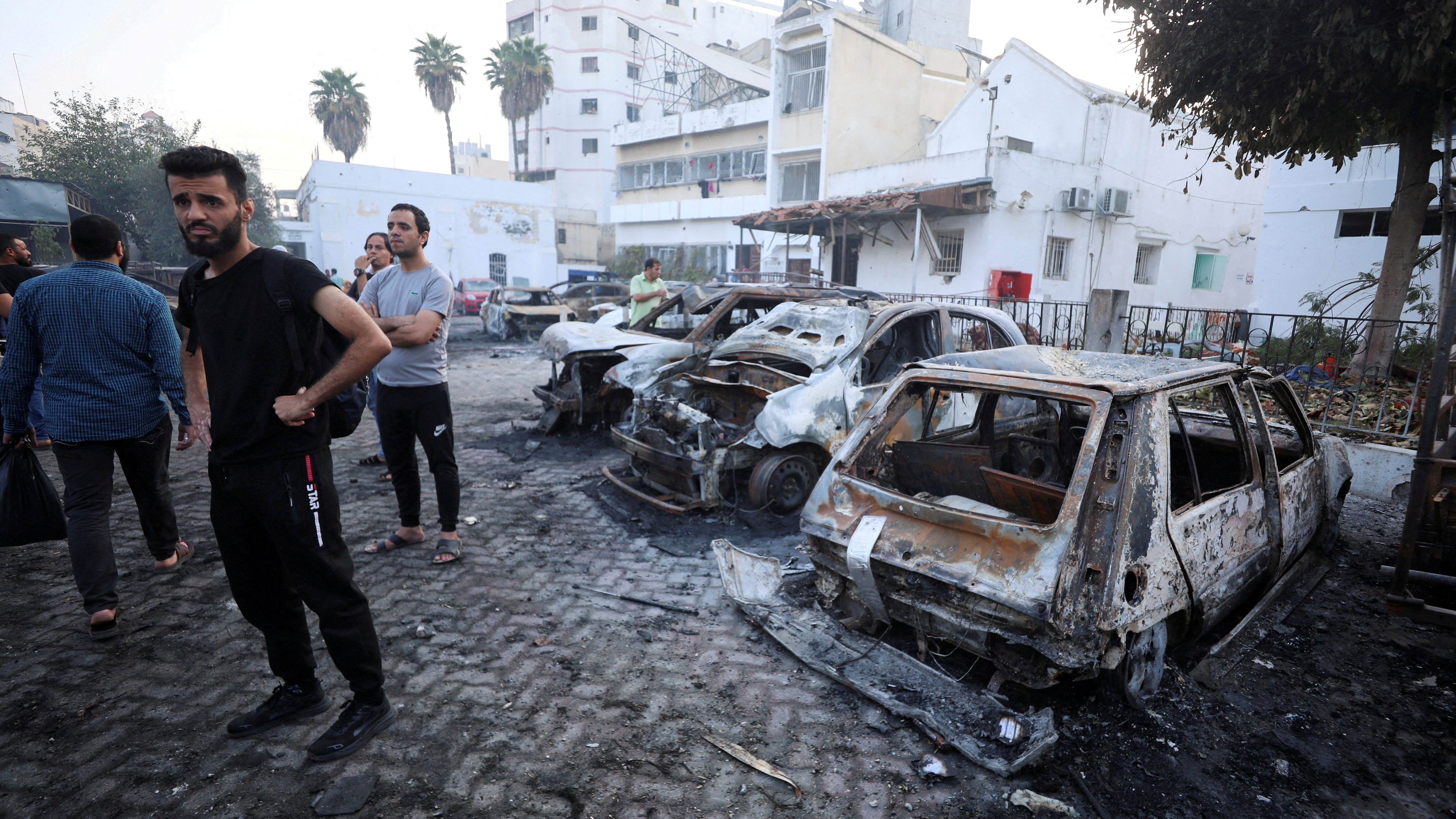 People inspect the area of Al-Ahli hospital where hundreds of Palestinians were killed in a blast. /Mohammed Al-Masri/Reuters