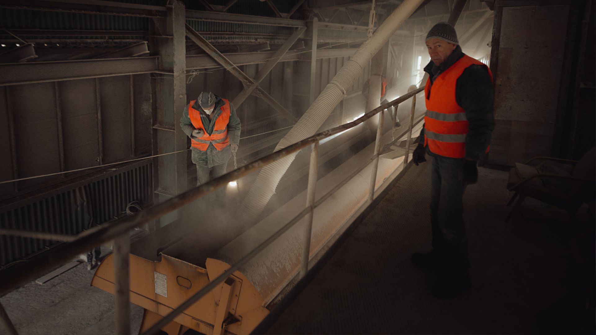 Ukrainian workers inspect the emptying process of a rail wagon full of grain inside a silo belonging to the Swedish- Ukrainian BZK Grain Alliance firm. /Robert Nemeti/Anadolu Agency via Getty Images