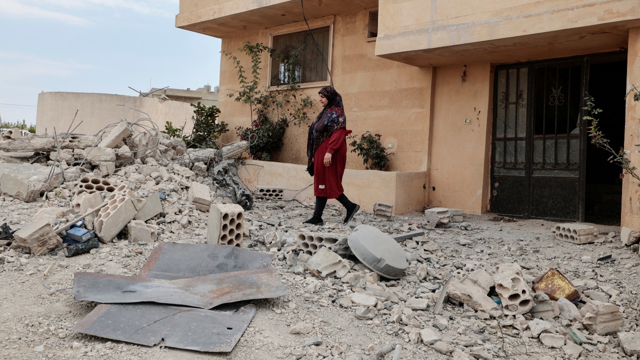 Hiba, 28, walks amid rubble after her family house was damaged, by what she said was an Israeli shell, in the southern town of Yater, Lebanon. /Zohra Bensemra/Reuters