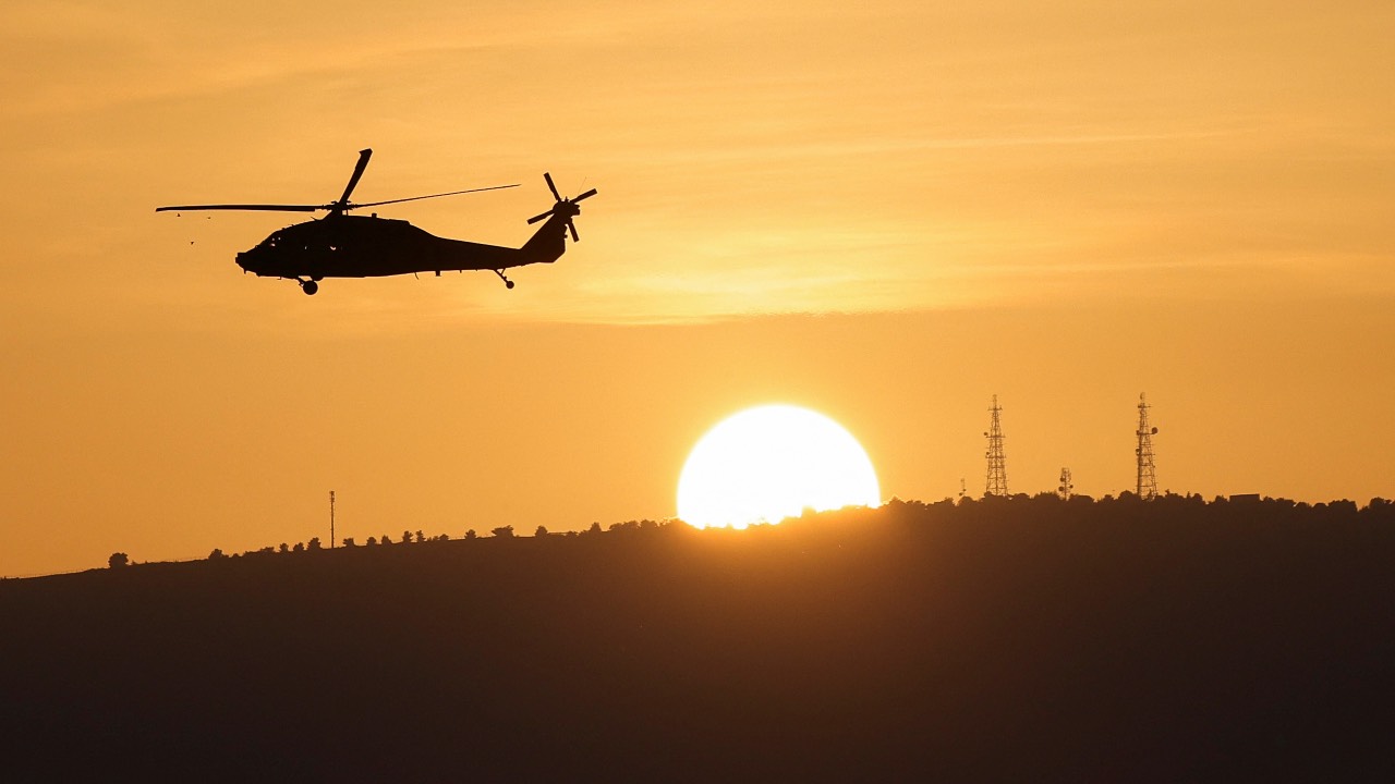 An Israeli military helicopter flies over Northern Israel near the border with Lebanon. /Violeta Santos Moura/Reuters