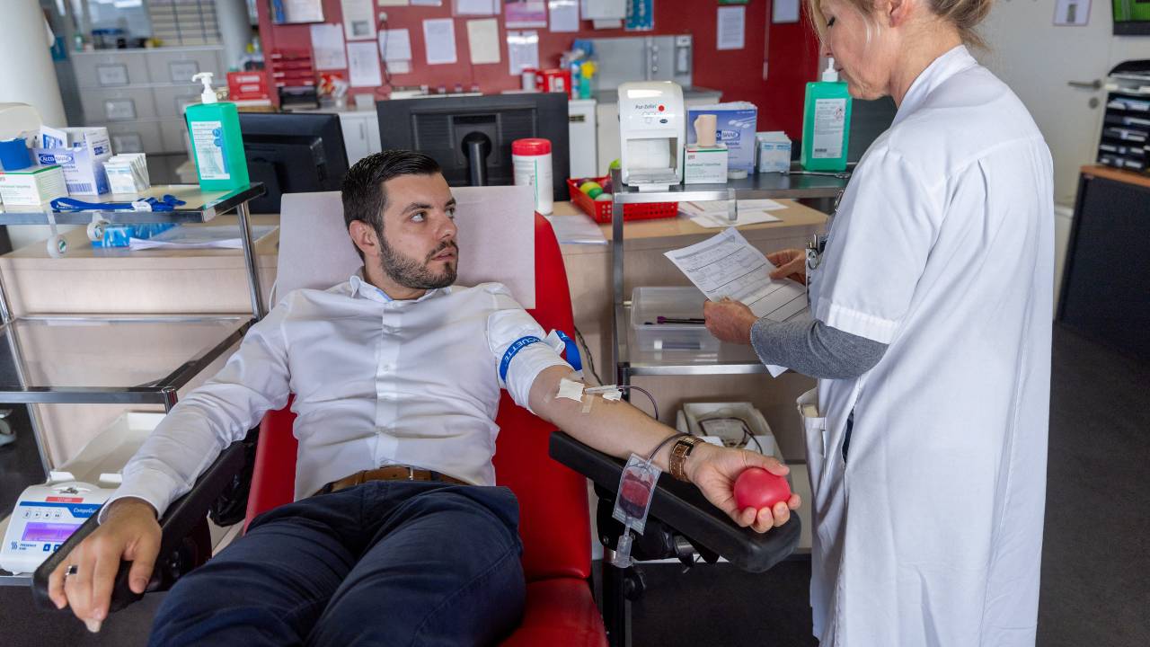 A nurse checks on Gabriel Delabays during a blood donation after Switzerland lifted long-standing restrictions on gay men giving blood near Lausanne. /Denis Balibouse/Reuters