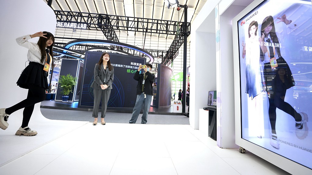 A visitor interacts with the digital figure at the Light of Internet Expo of the World Internet Conference. /CFP
