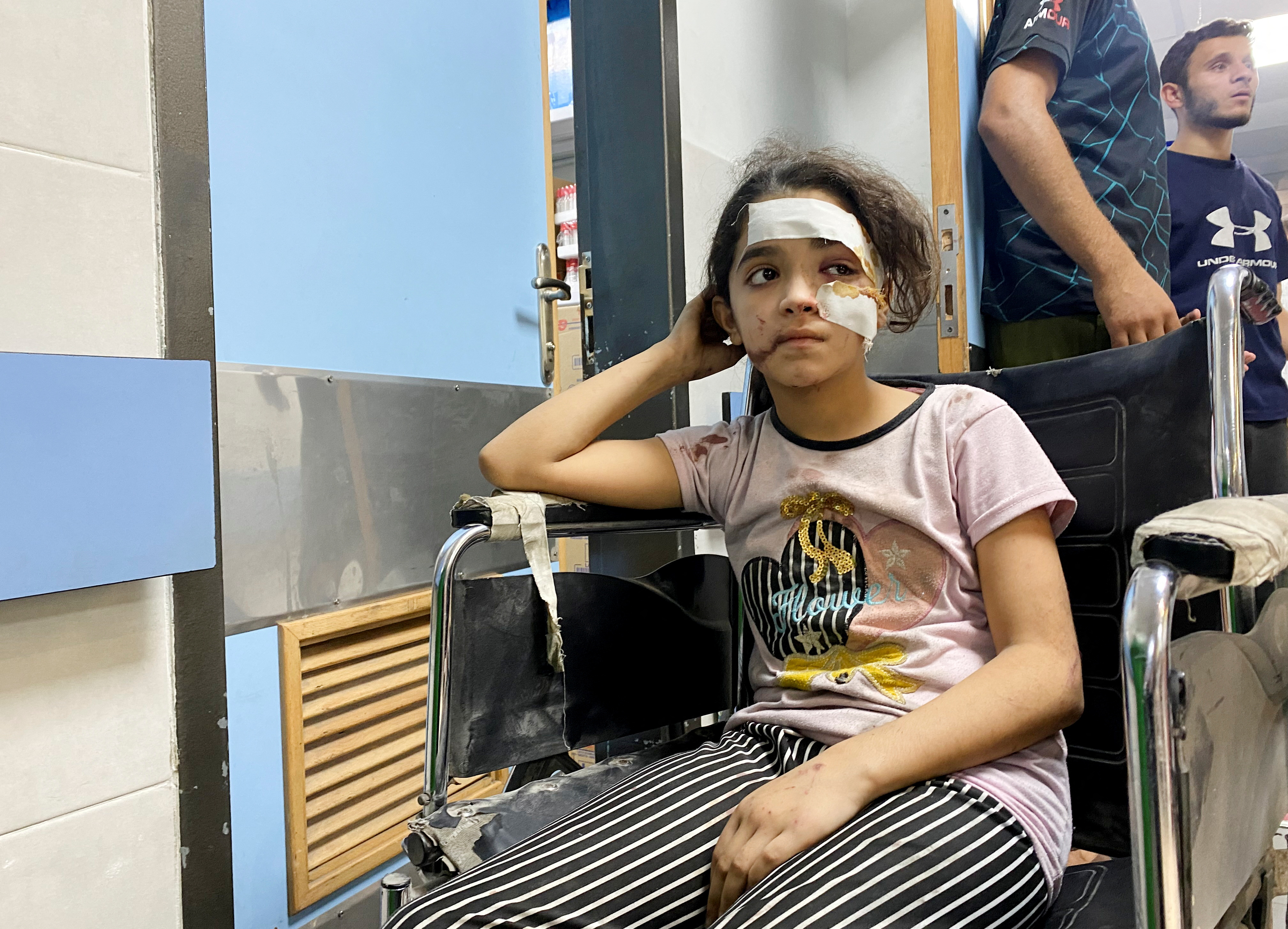 A wounded Palestinian girl waits at Al Shifa hospital, in Gaza City. But as she seeks safety and treatment, there are concerns the hospital could be struck by Israeli strikes. /Doaa Rouqa/Reuters
