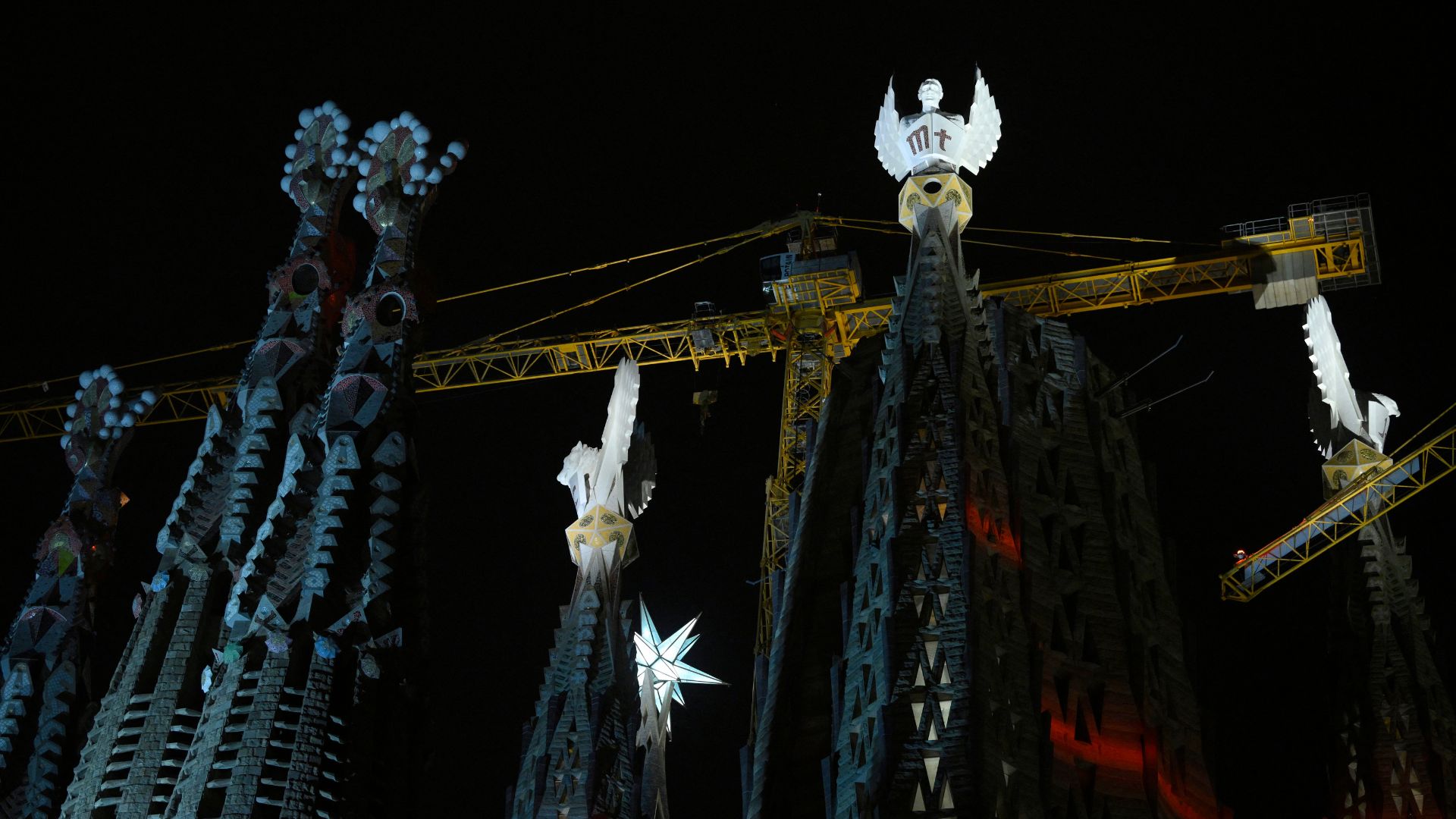 The Sagrada Familia basilica's towers of the Evangelists are lit up for the first time. /Josep Lago/AFP