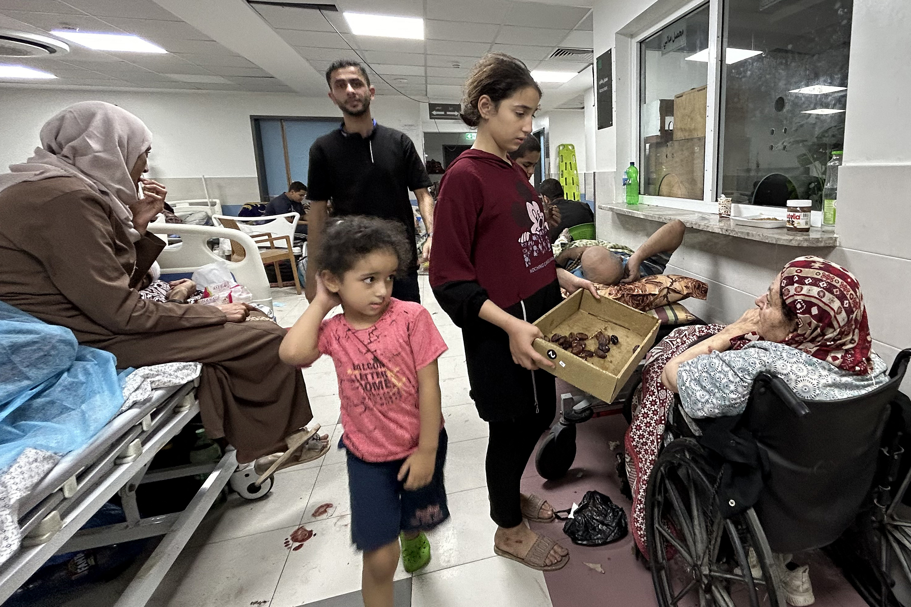 Patients and refugees at Al-Shifa hospital. Khader Al Zanoun/ AFP
