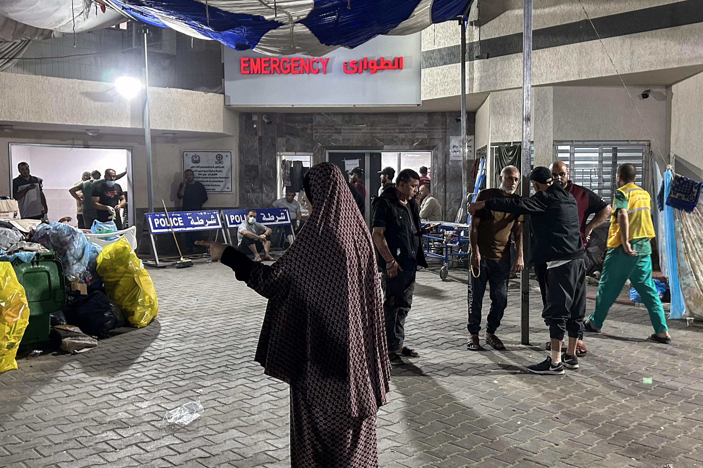 People stand outside the emergency ward of Al-Shifa hospital. /Khader Al Zanoun/AFP