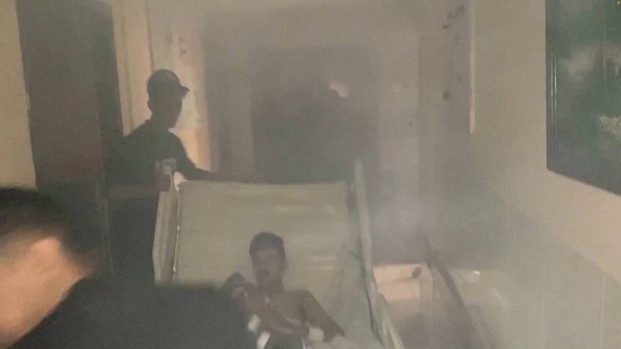 Medics move a patient through the smoke-filled corridors inside Al-Shifa hospital following an Israeli raid in Gaza City. /Gaza Ministry Of Health/Reuters