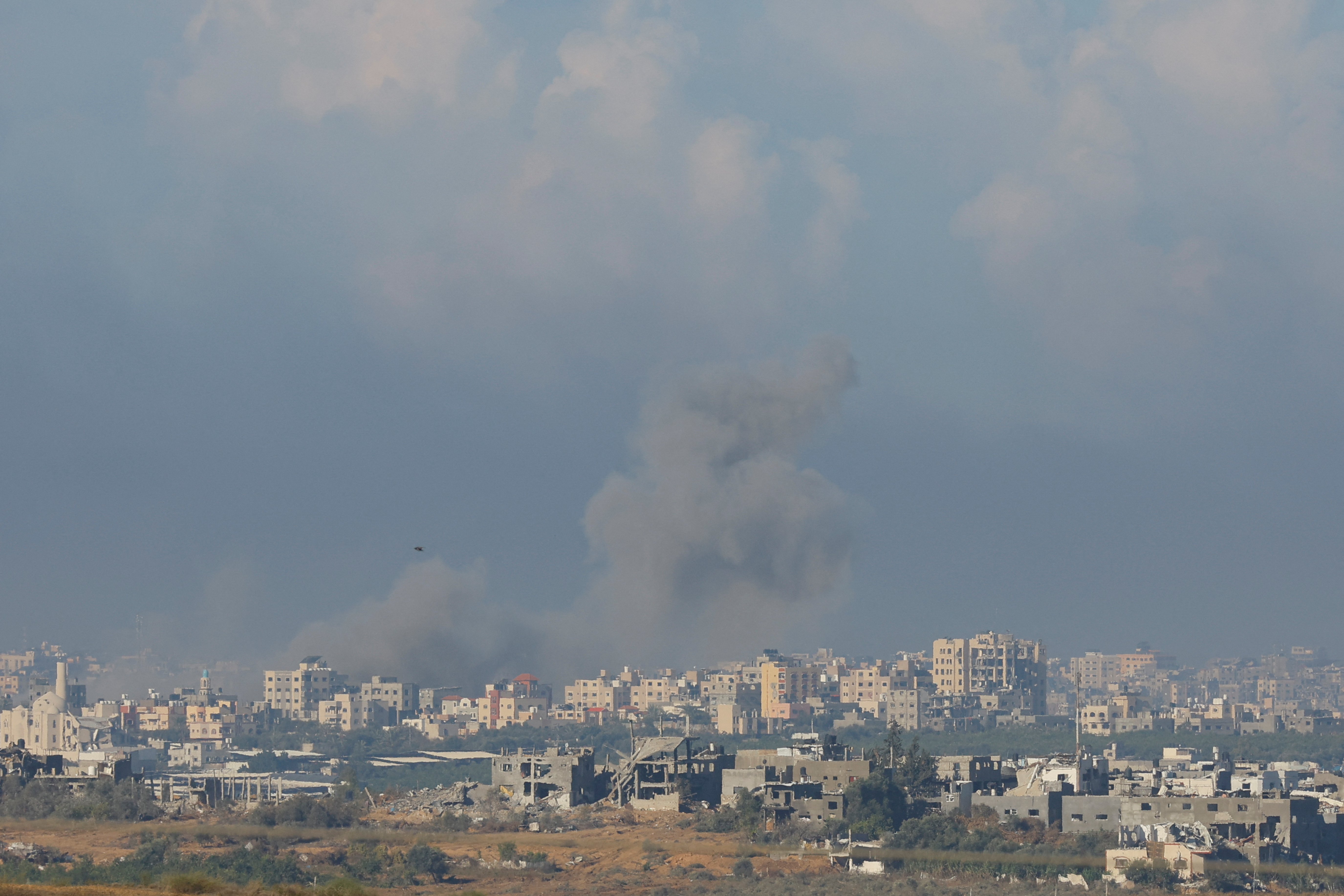 Smoke and dust rise after an explosion in Gaza, as seen from southern Israel. /Alexander Ermochenko/Reuters
