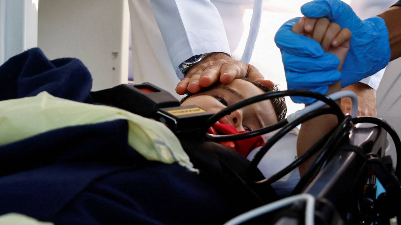 Medics receive an injured Palestinian boy in Abu Dhabi, United Arab Emirates. /Rula Rouhana/Reuters